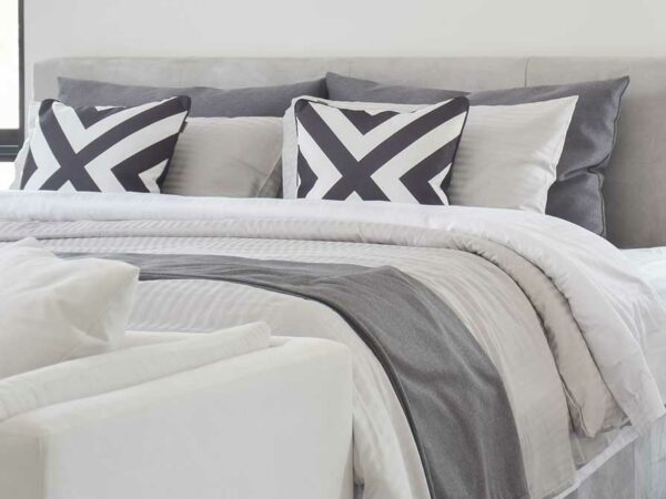 Modern Gray tone bedding and bedside table and lamp in black