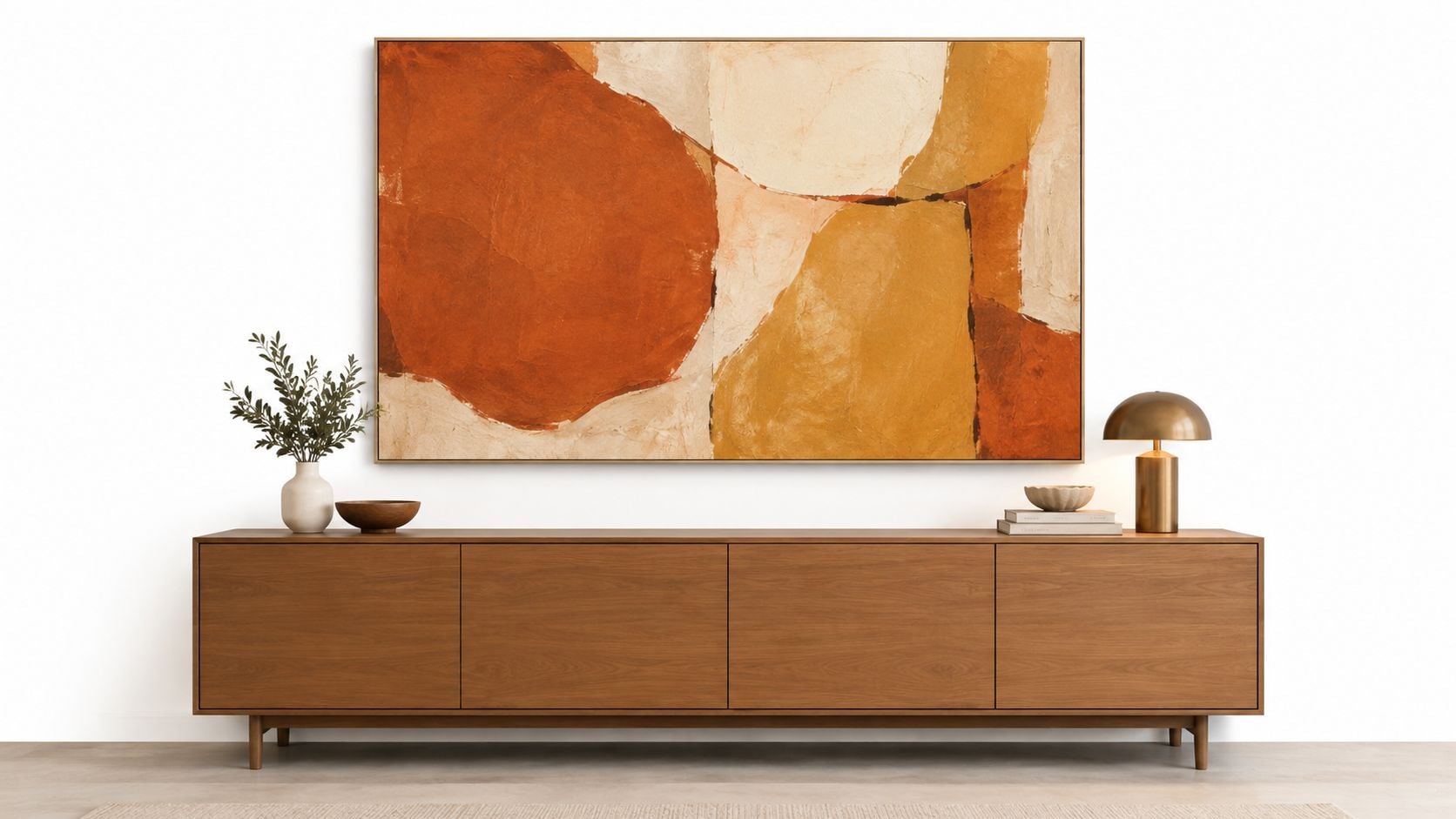 A modern wooden sideboard featuring an abstract orange and gold painting hanging above it in a minimalist room.