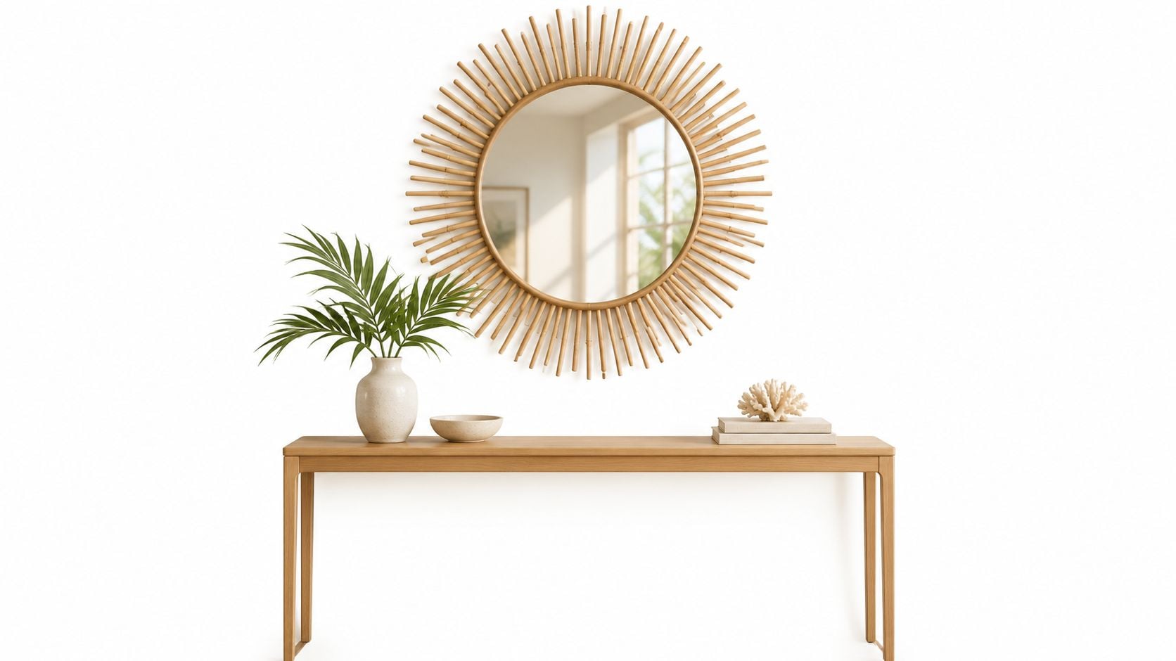 A modern wooden console table with a sunburst mirror above and a small plant, bowl, and coral sculpture.